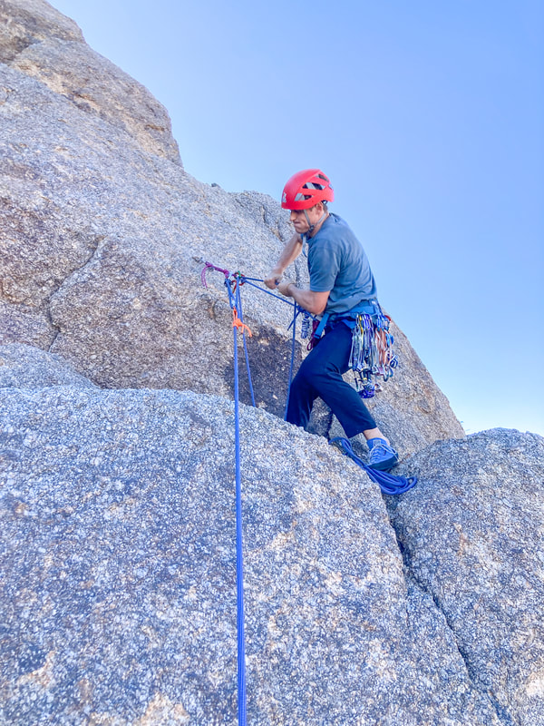Climber hauling a person with rope